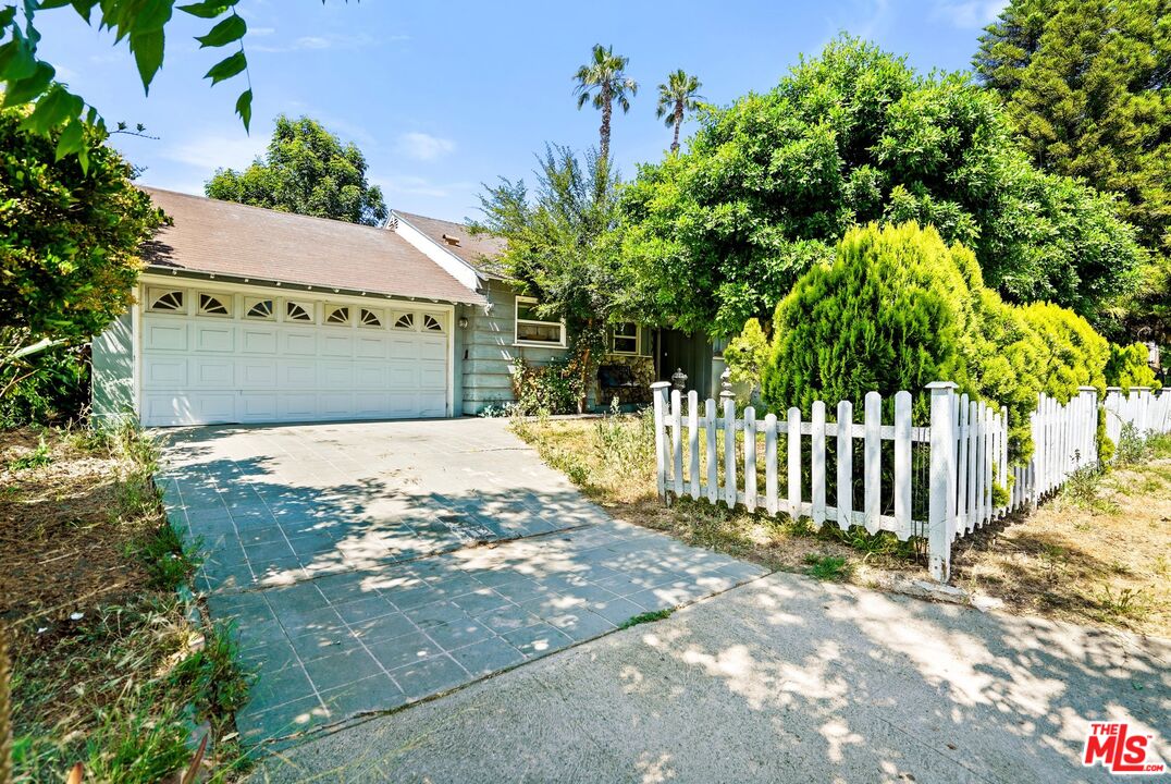 a view of a house with a small yard