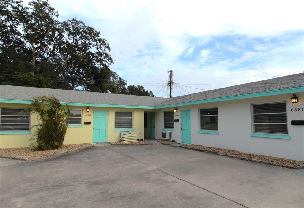 a view of a house with a backyard and garage