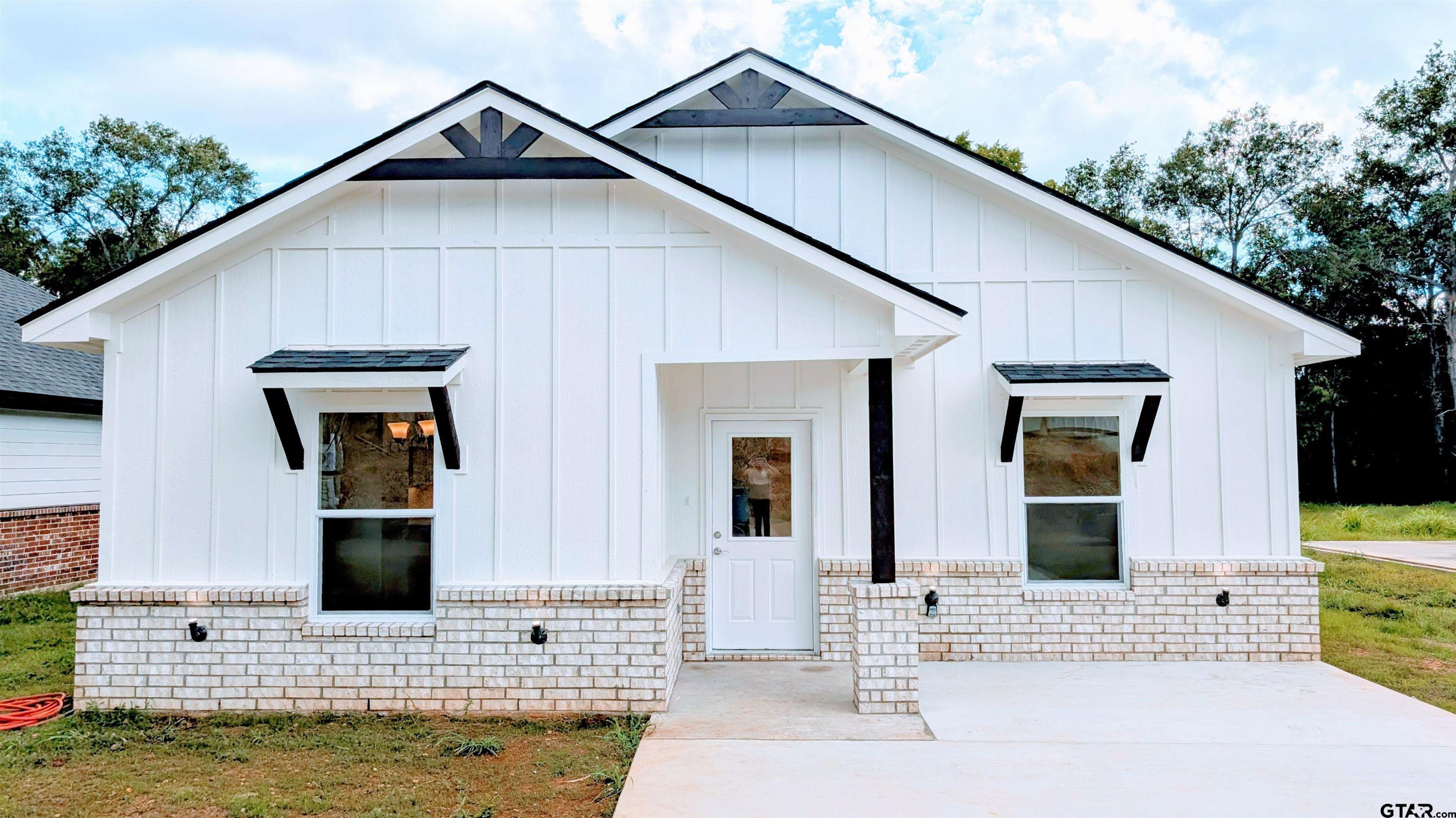 a view of front door and a yard