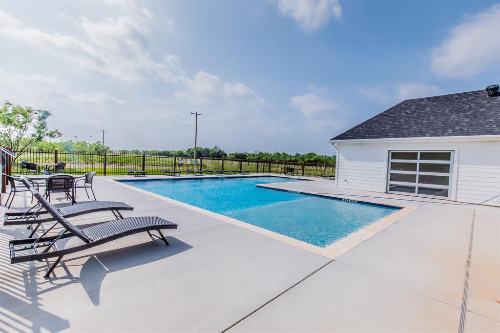 a view of a swimming pool and a yard