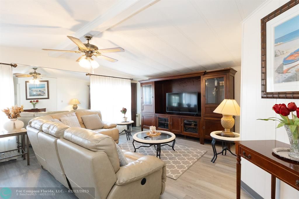 a living room with furniture a rug and a chandelier