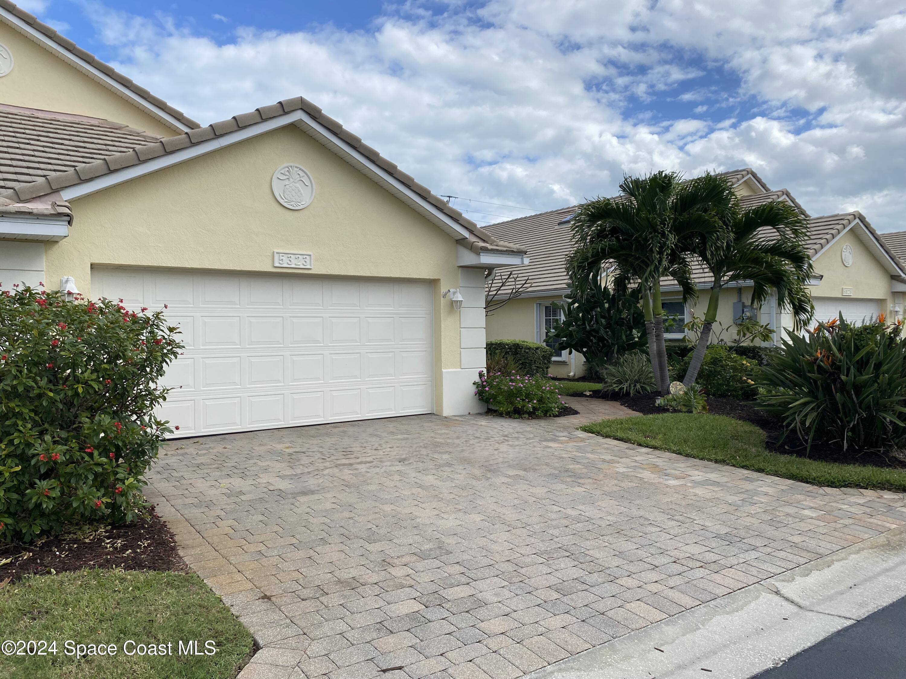 a house with palm tree in front of it