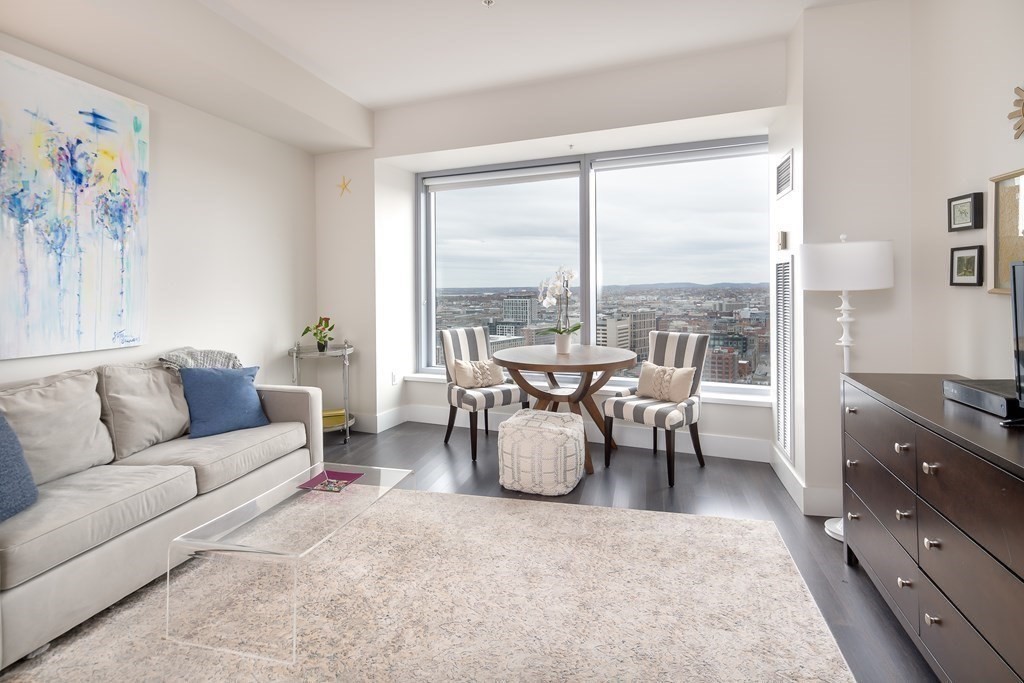 a living room with furniture and a floor to ceiling window