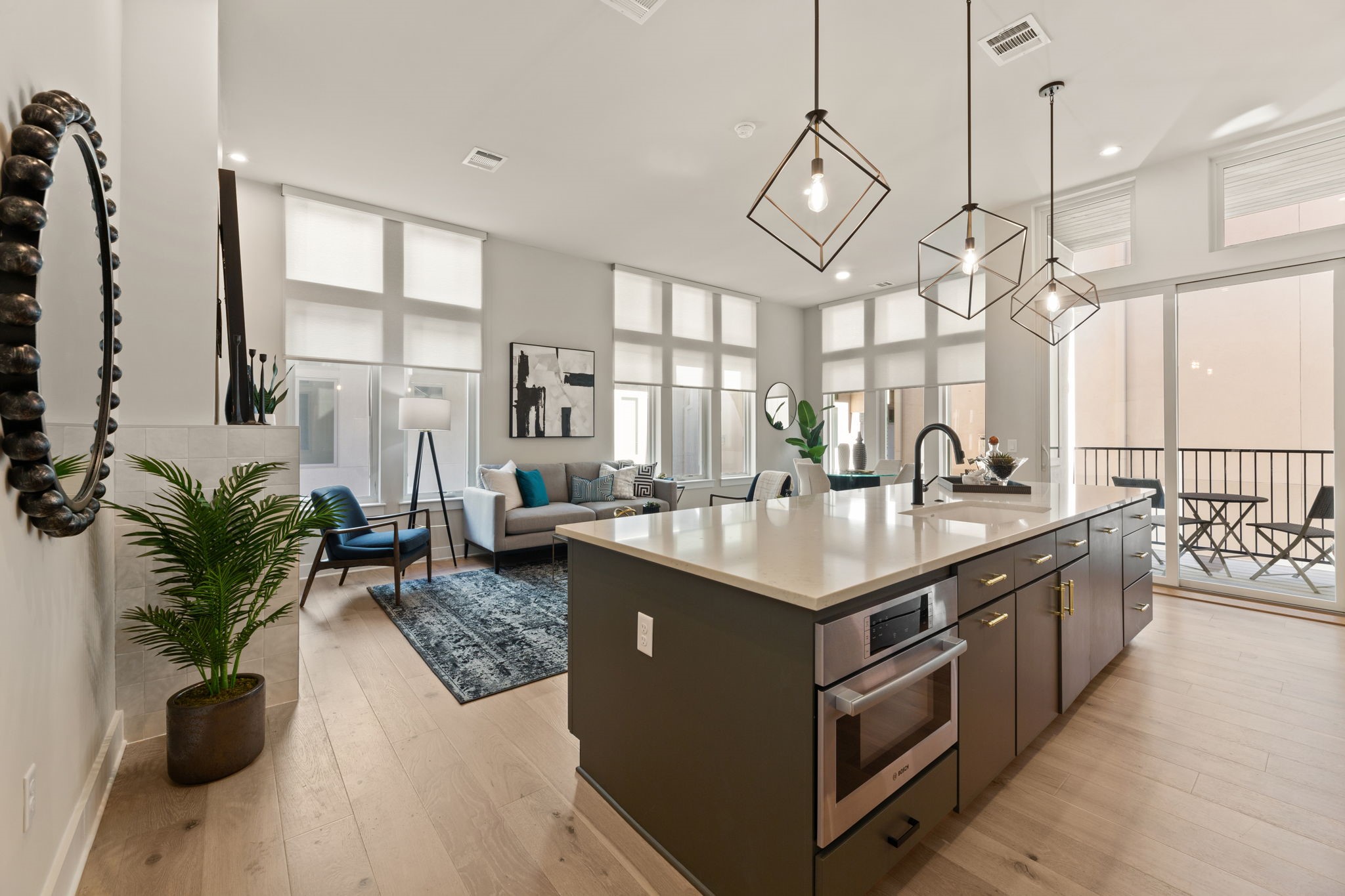 a kitchen with sink stove and large trees