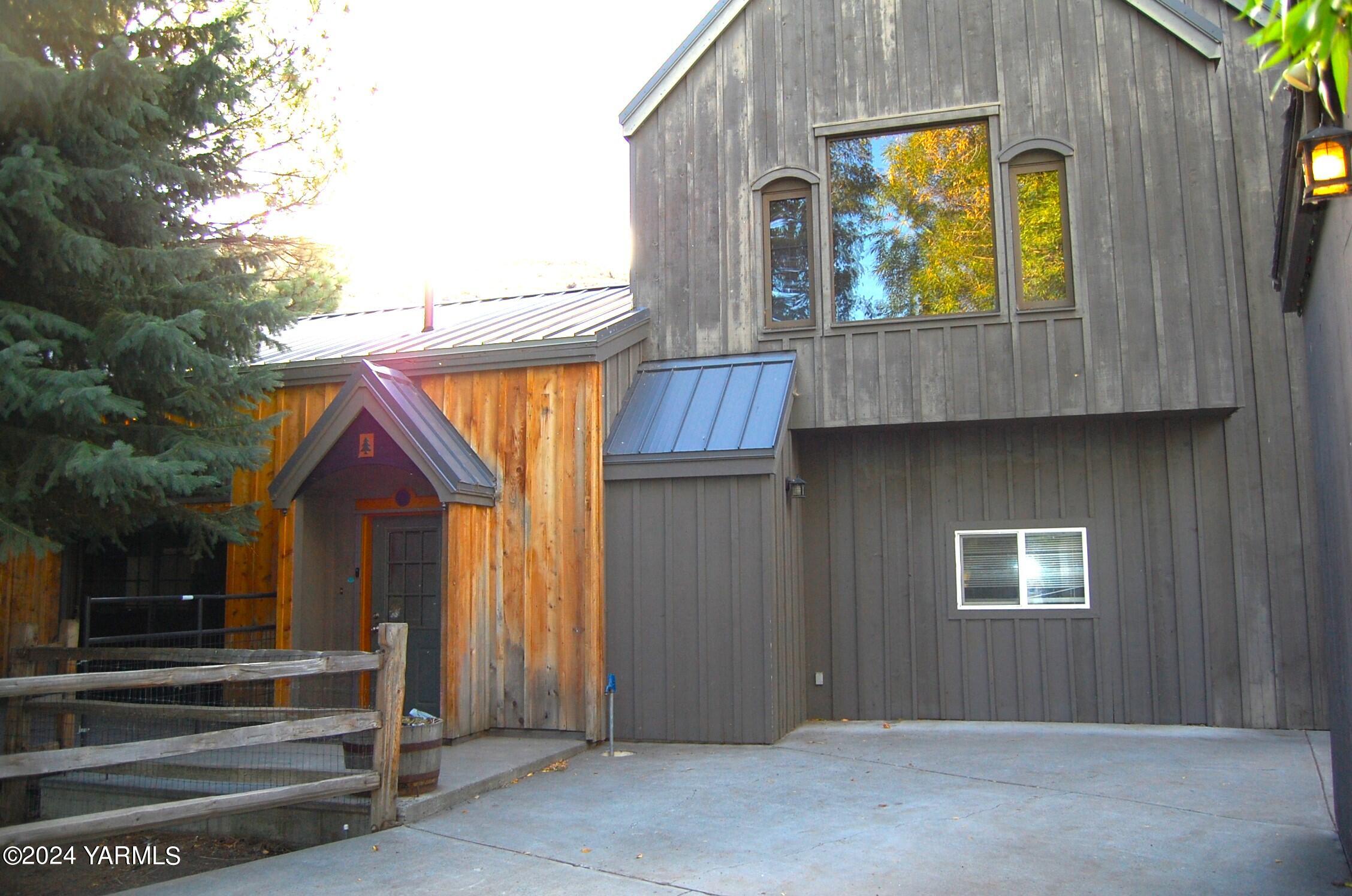 a view of entrance with yellow house