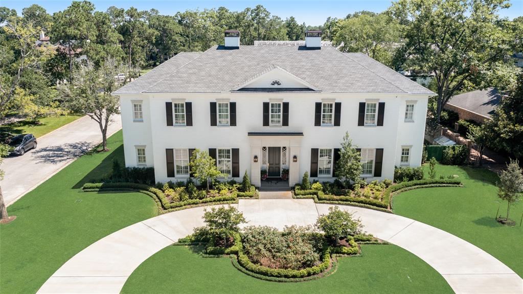 a aerial view of a house with swimming pool garden and patio