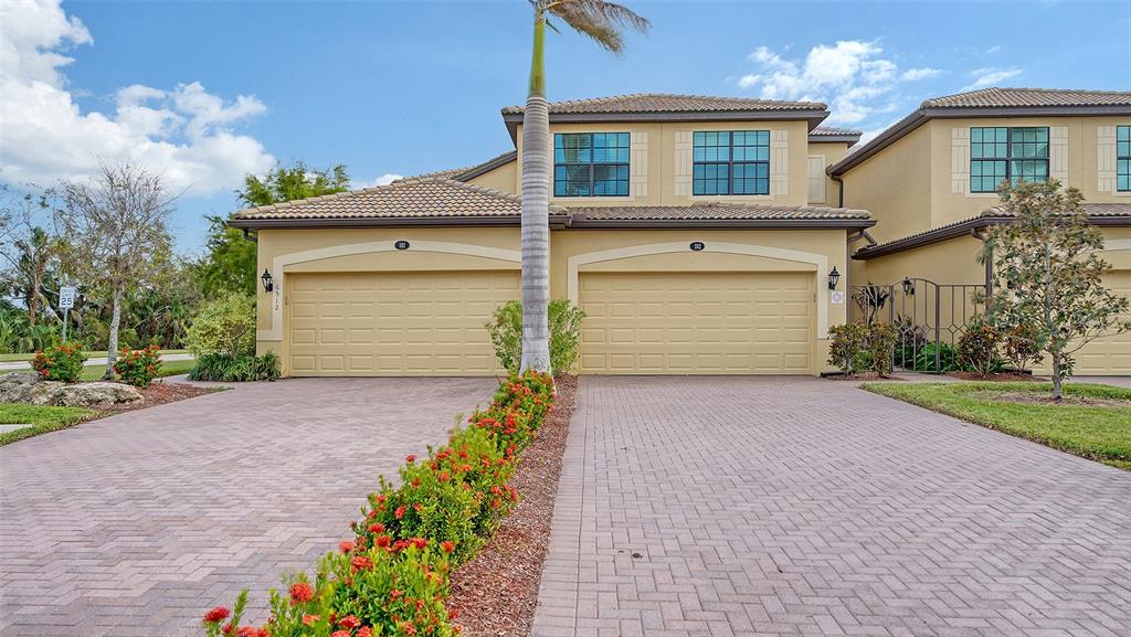 front view of a house with a yard and a garage