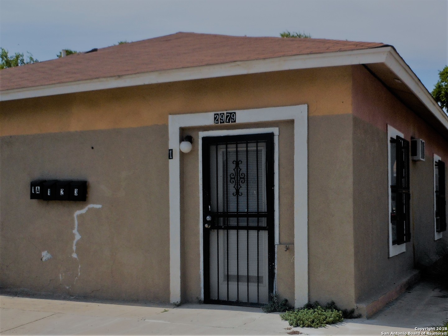 a front view of a house with parking space