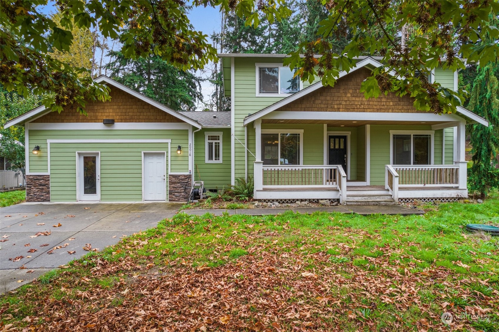 a front view of a house with yard and green space