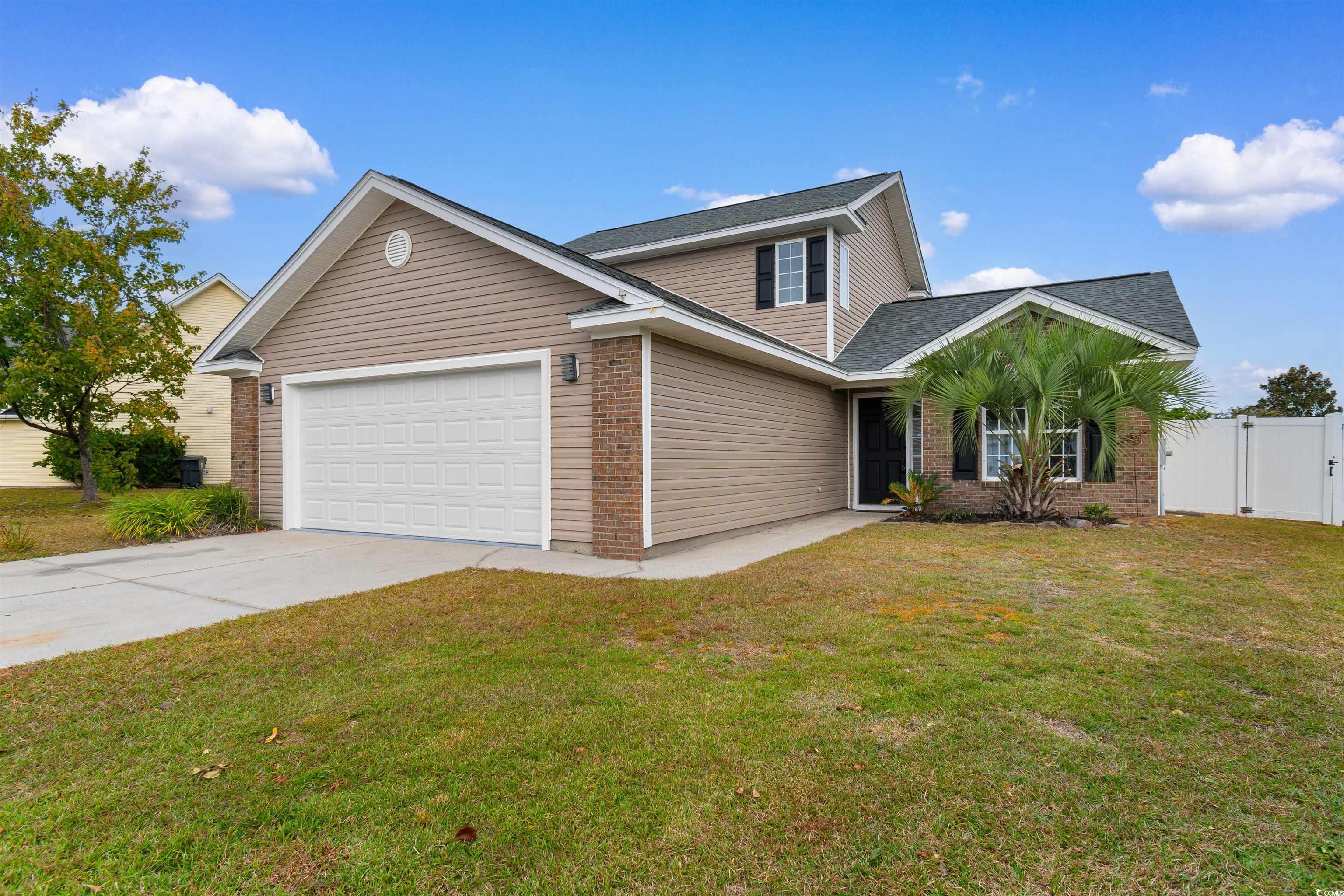 Front facade with a garage and a front lawn