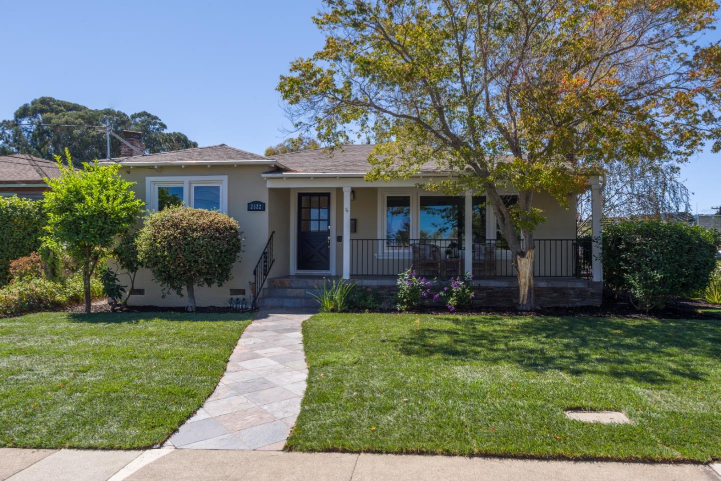 a front view of a house with a yard and garage