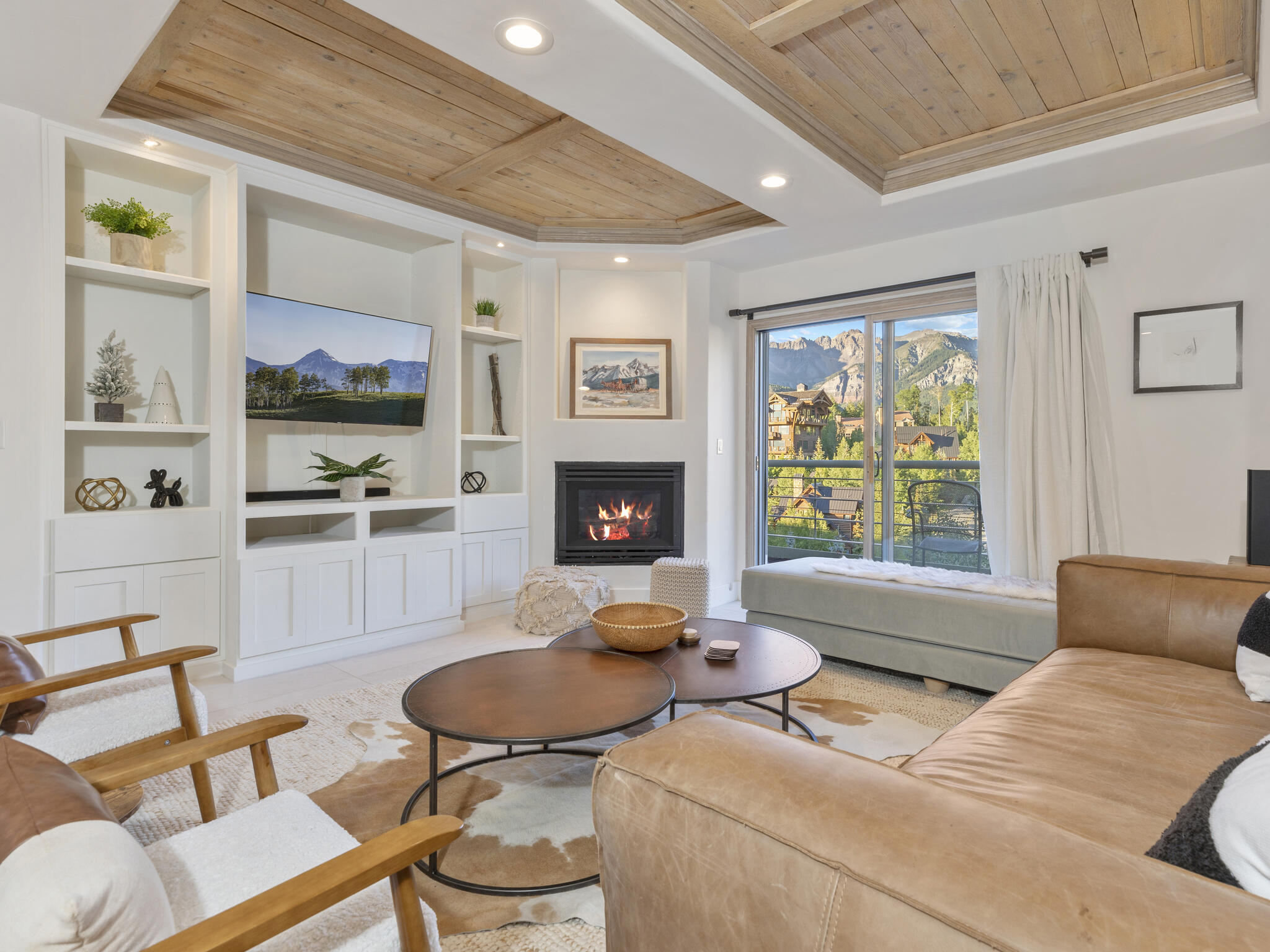 a living room with furniture fireplace and flat screen tv