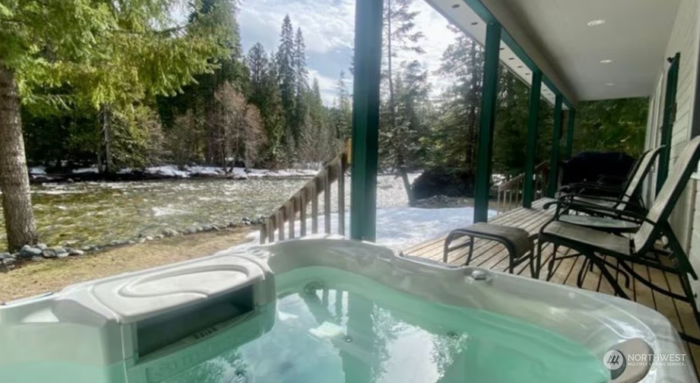 a view of a swimming pool with a patio and fire pit