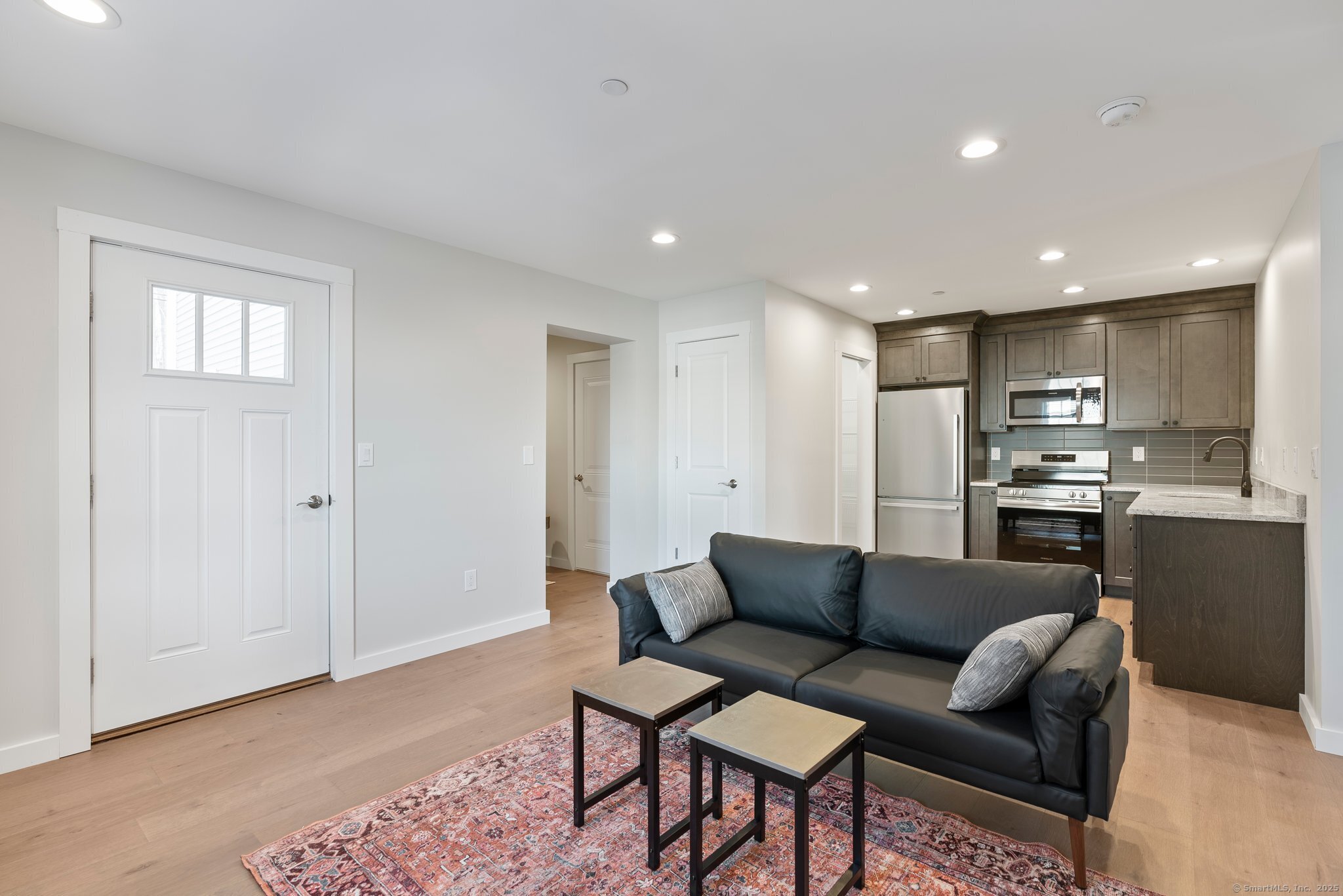 a living room with furniture and kitchen view