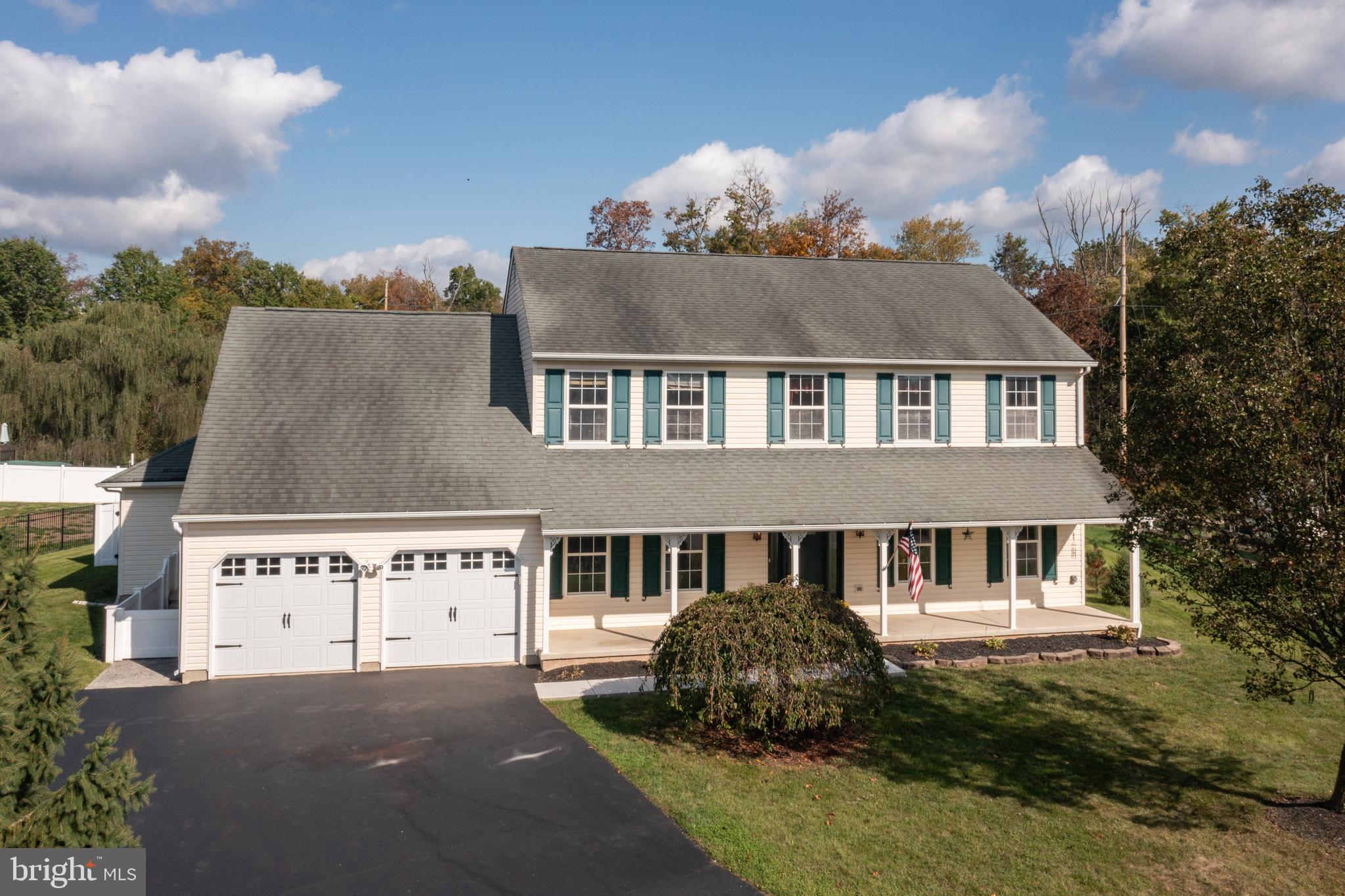 a front view of house with yard and trees around