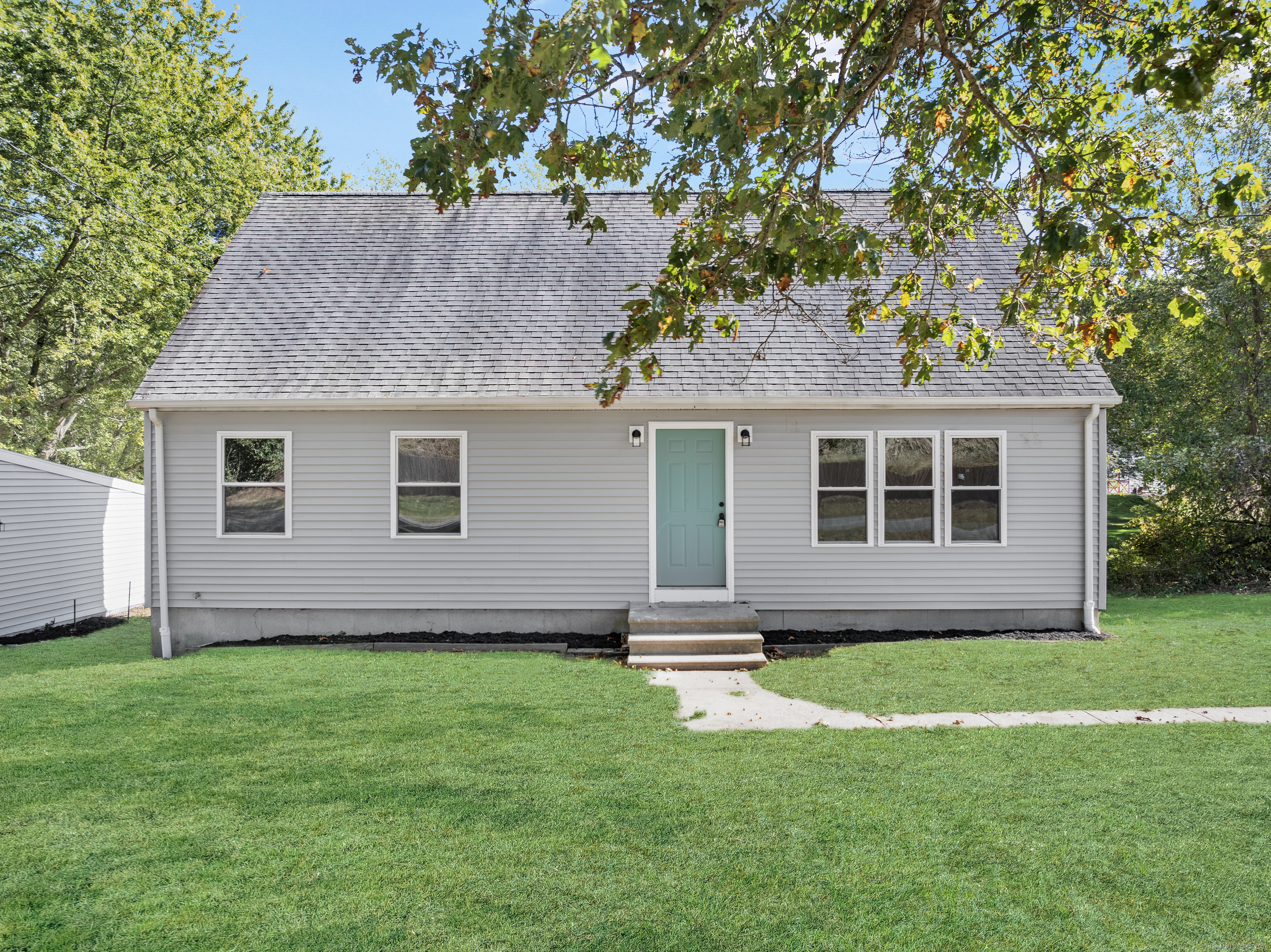 a view of a house with a yard and a garden