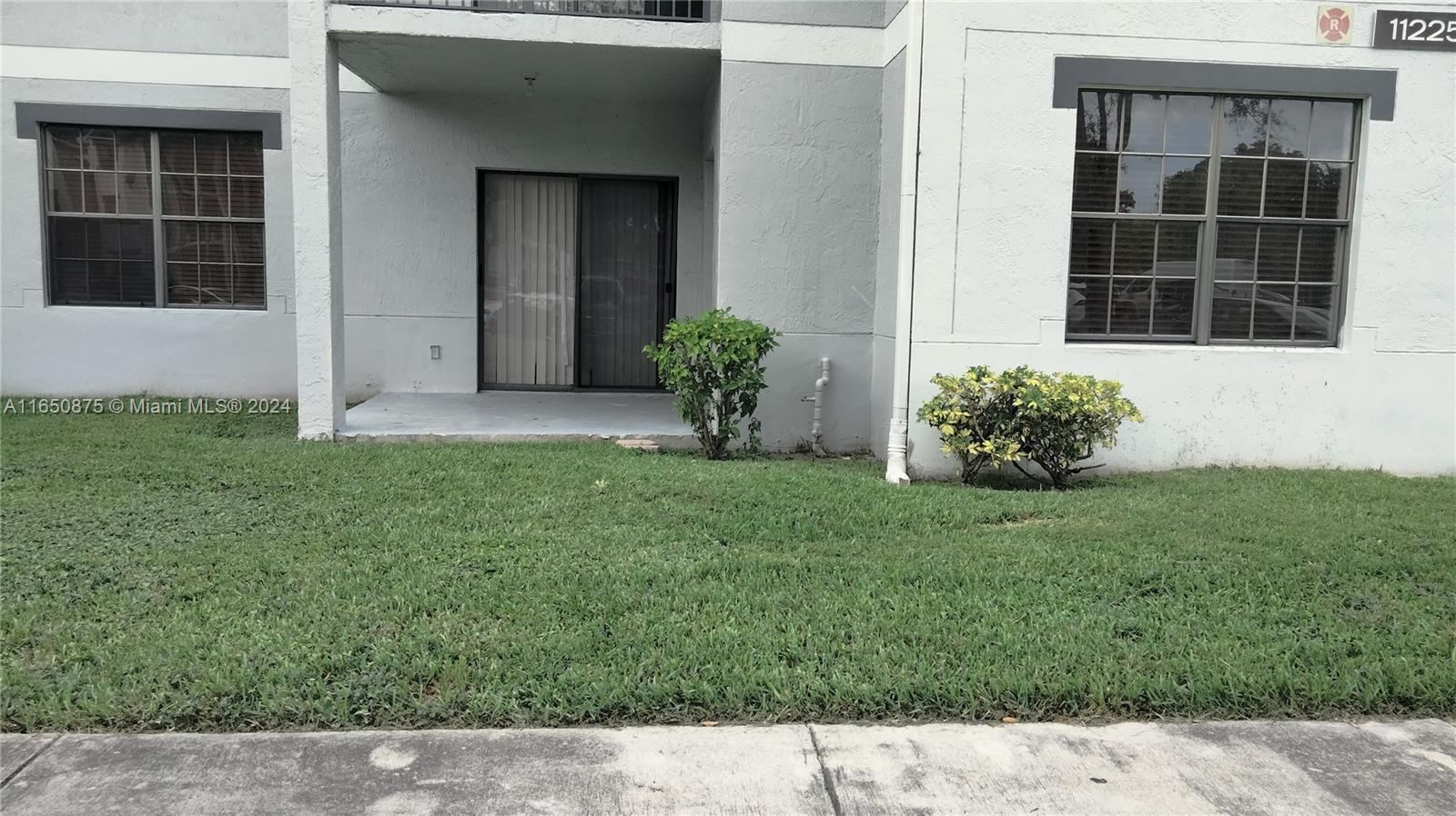 a view of front door of house and yard