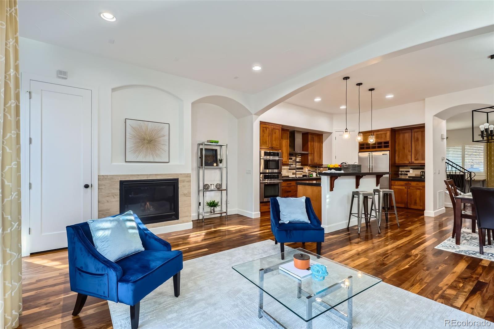 a living room with furniture and kitchen view