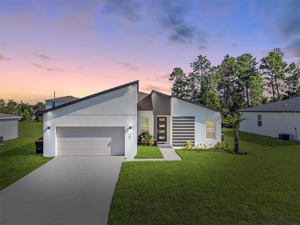 a front view of a house with a yard and garage