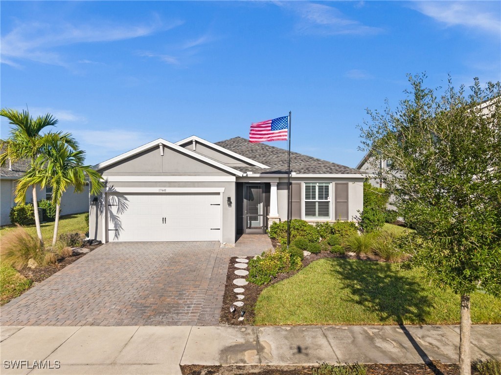 a front view of a house with a yard and garage