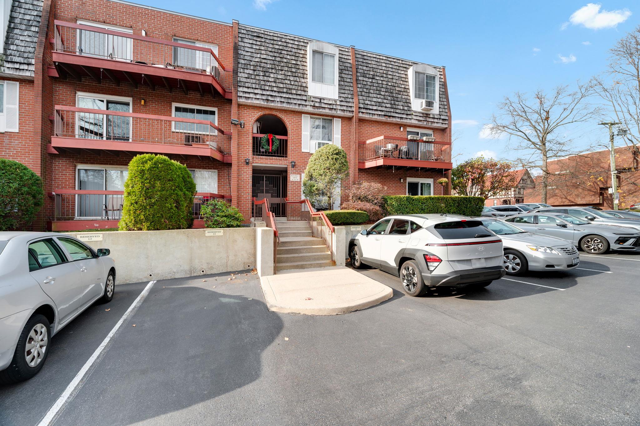 a view of a cars park in front of a building