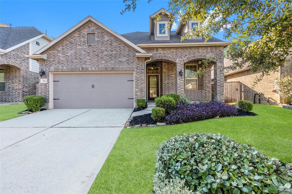 Welcome home to 146 Kinnerly Peak Pl! This stunning 1.5-story home in the sought-after Woodforest community combines classic charm with modern amenities, featuring a welcoming front porch and a beautifully landscaped yard.