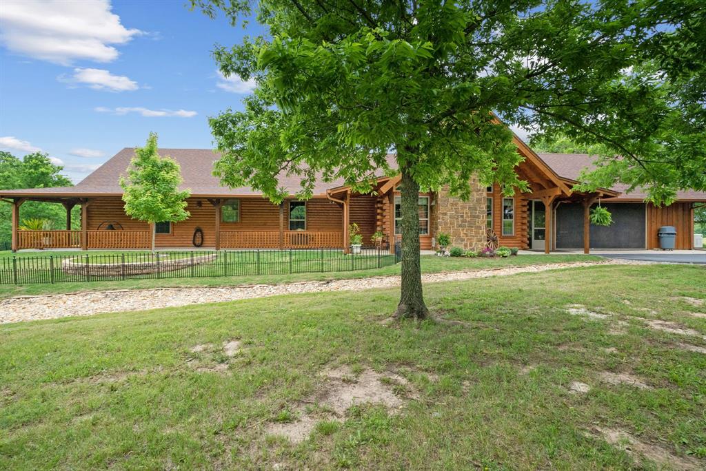 a view of a house with a backyard