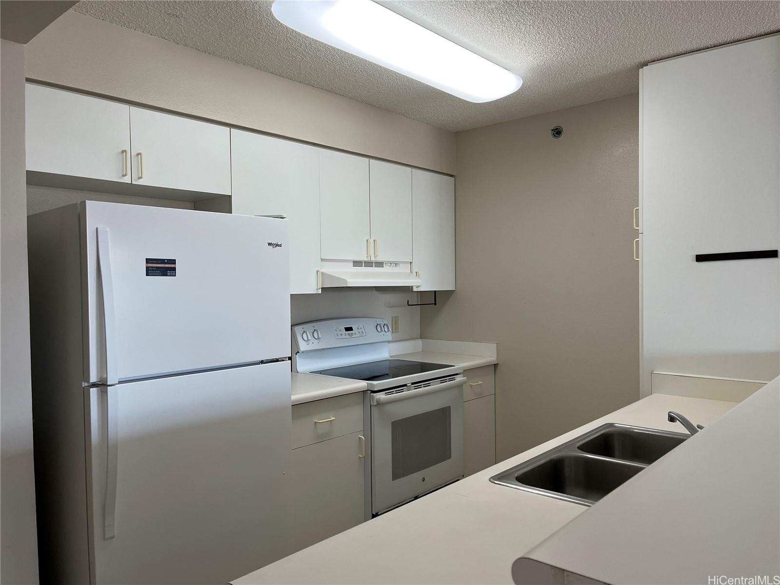 a kitchen with stainless steel appliances a refrigerator sink and cabinets