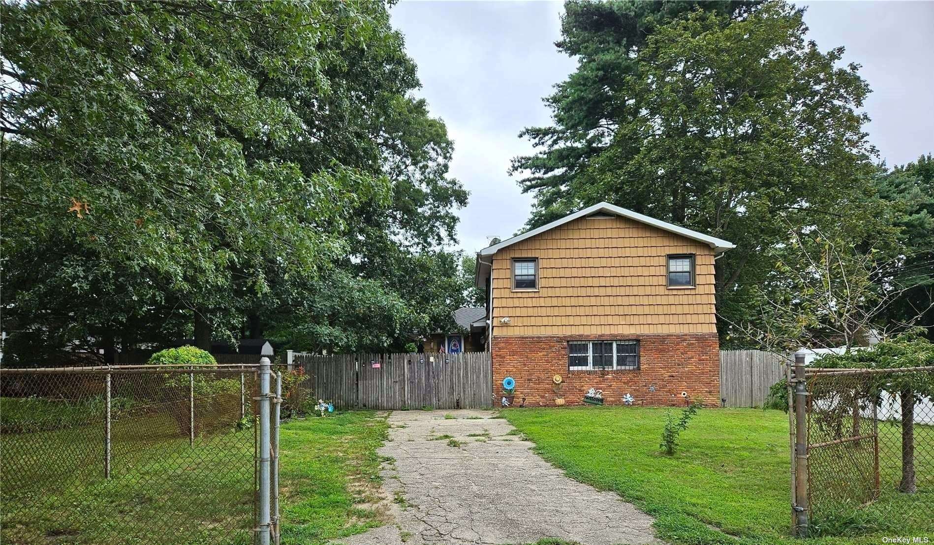 a front view of house with a garden