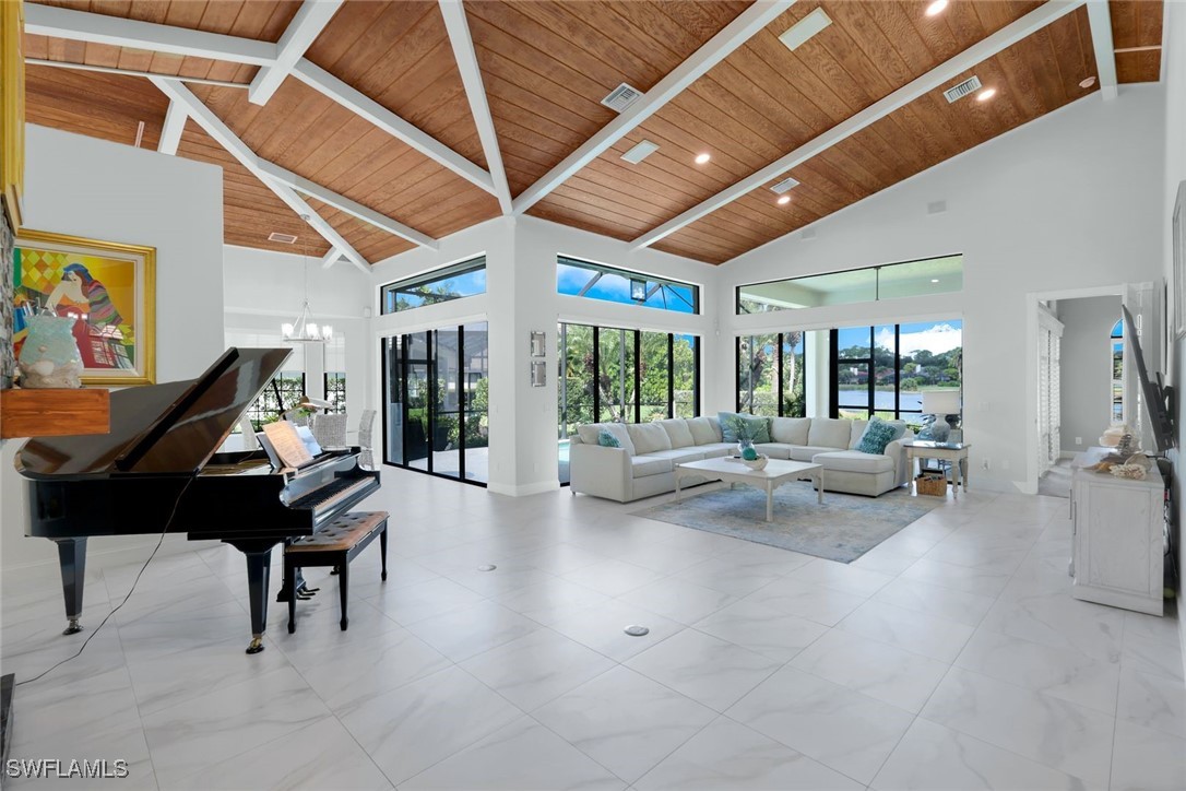 a living room with furniture and a floor to ceiling window