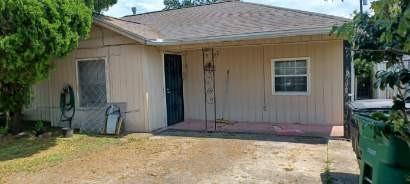 a view of house with backyard and trees