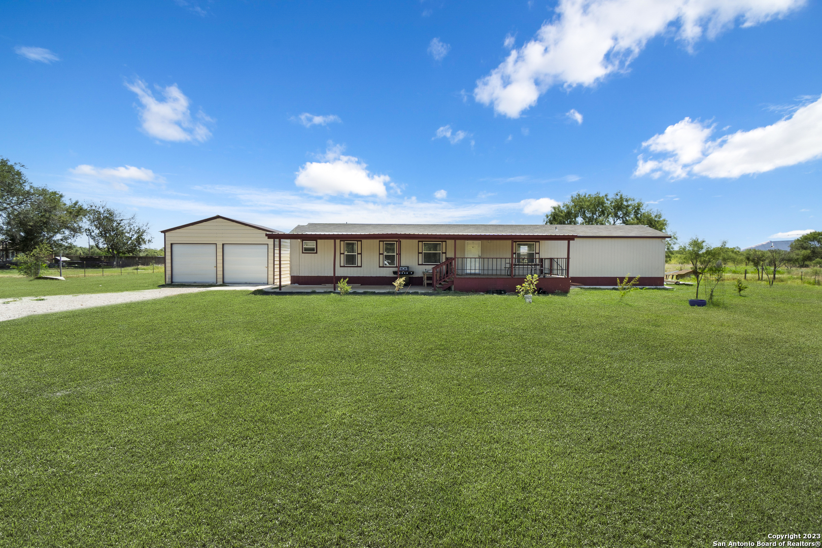 a front view of house with yard and green space