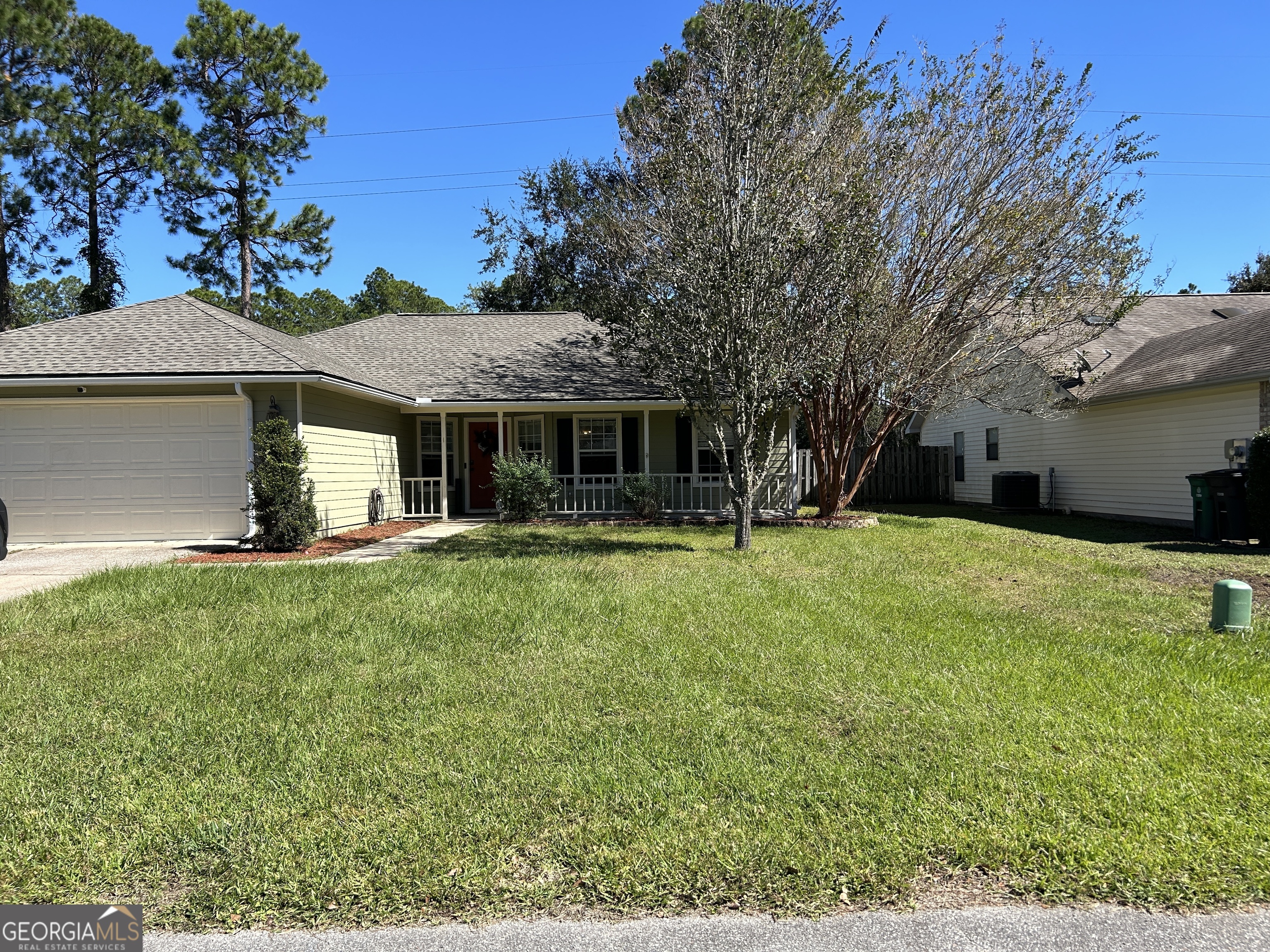 a front view of house with yard and green space