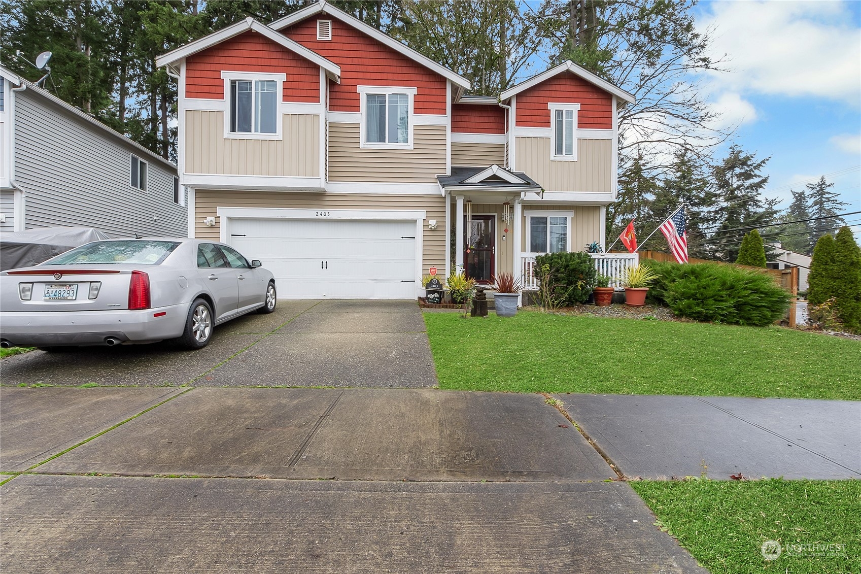 a front view of a house with a garden and parking