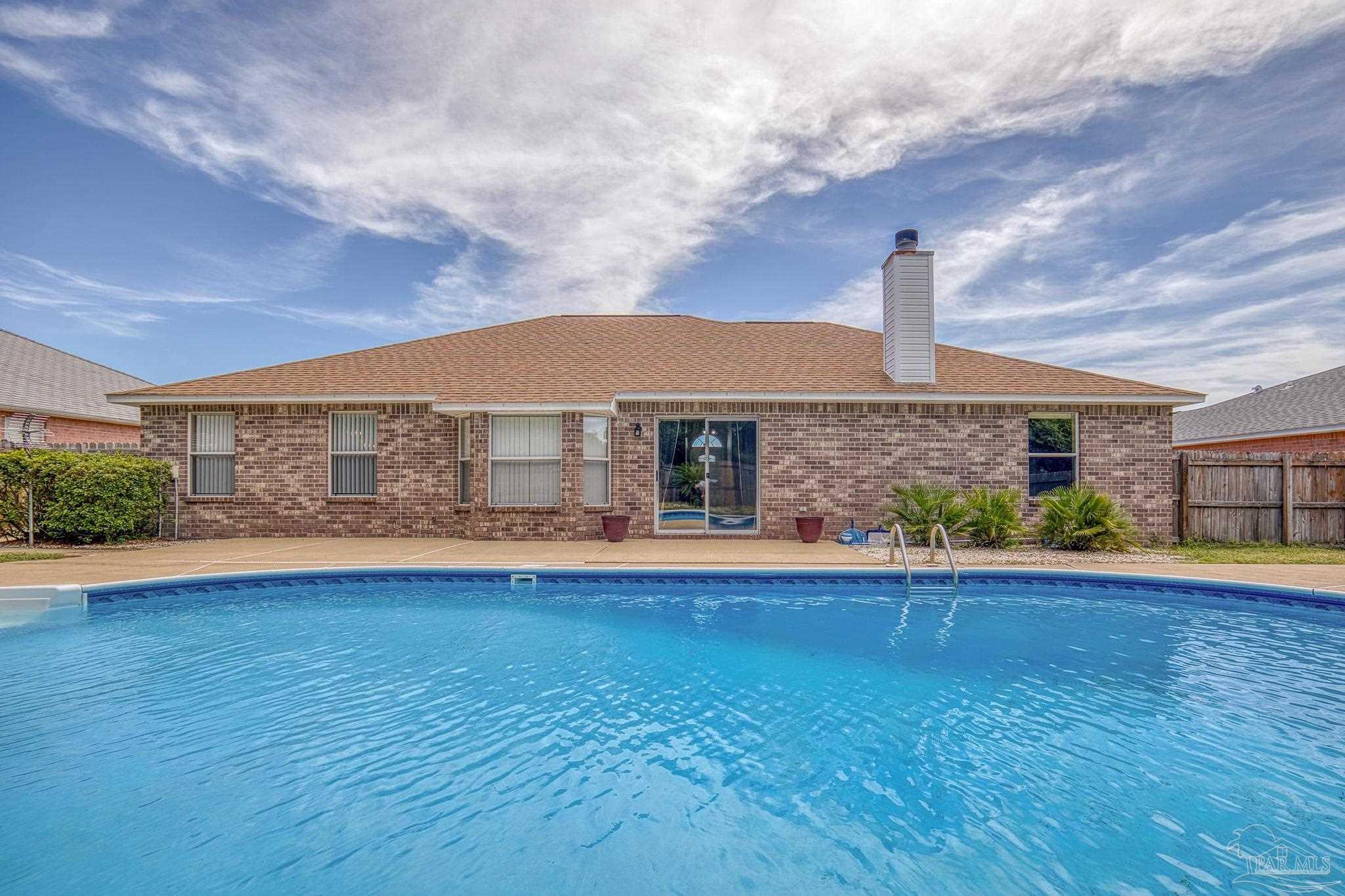 a front view of house with yard and outdoor seating