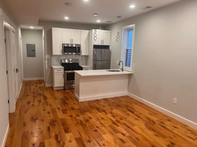 a view of kitchen with wooden floor