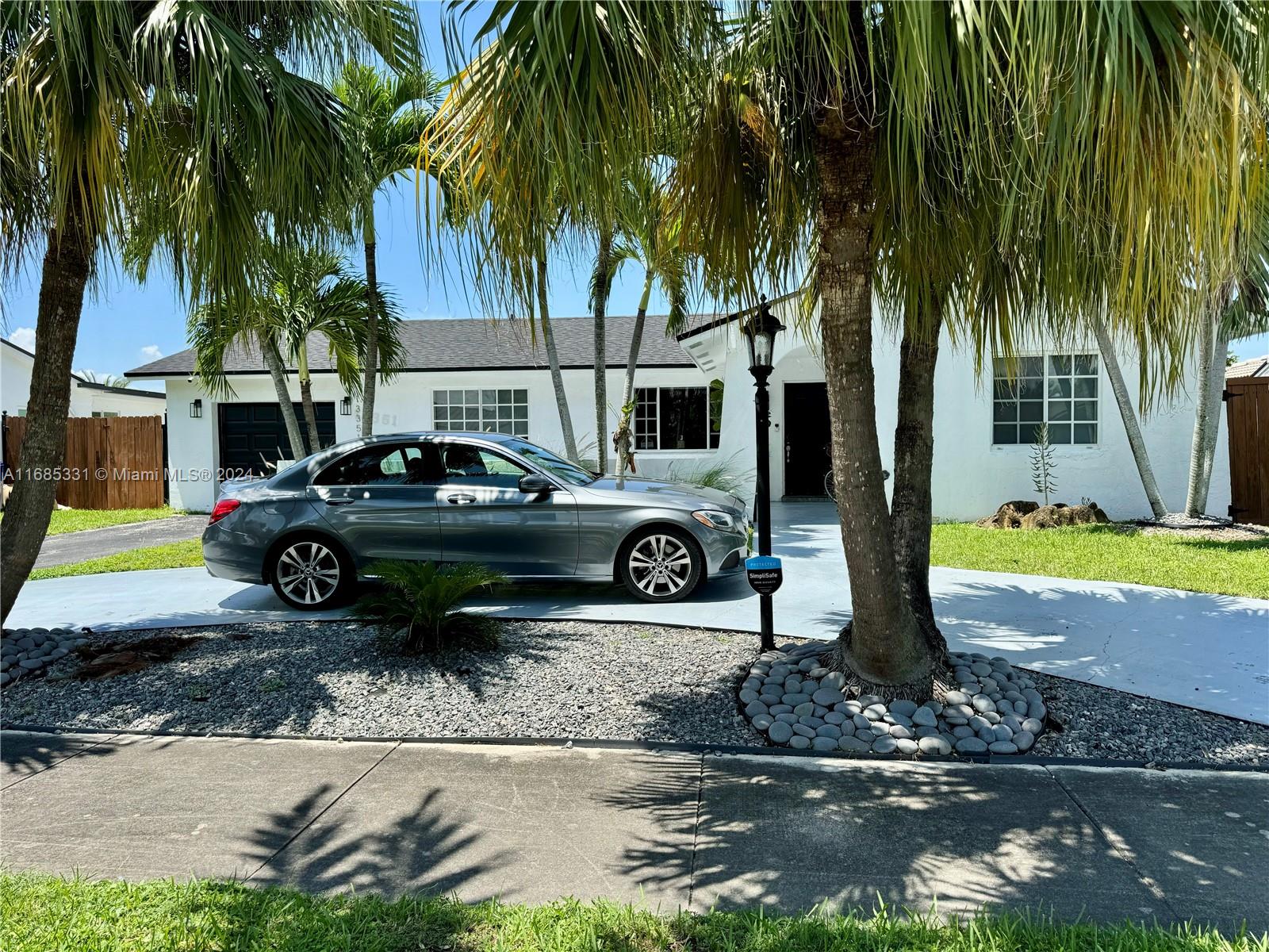 a view of a yard with cars