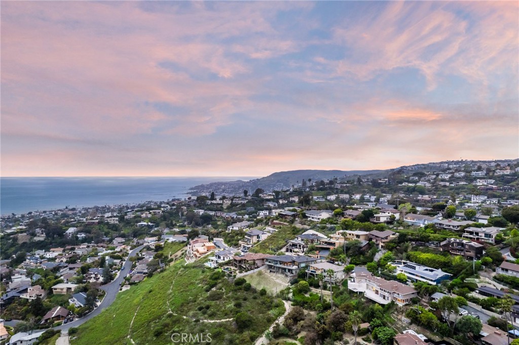 an aerial view of residential houses with city view