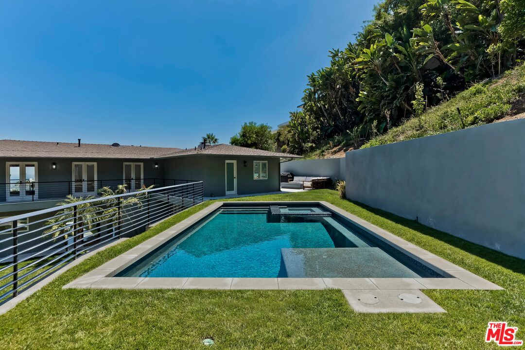 a view of swimming pool with chairs