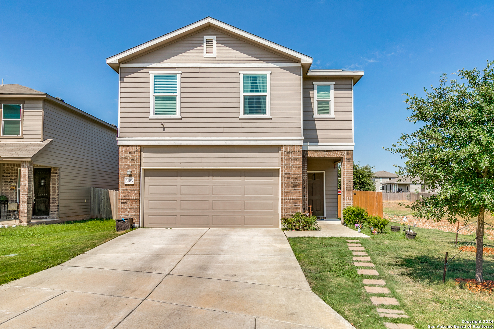 a front view of a house with a yard and garage