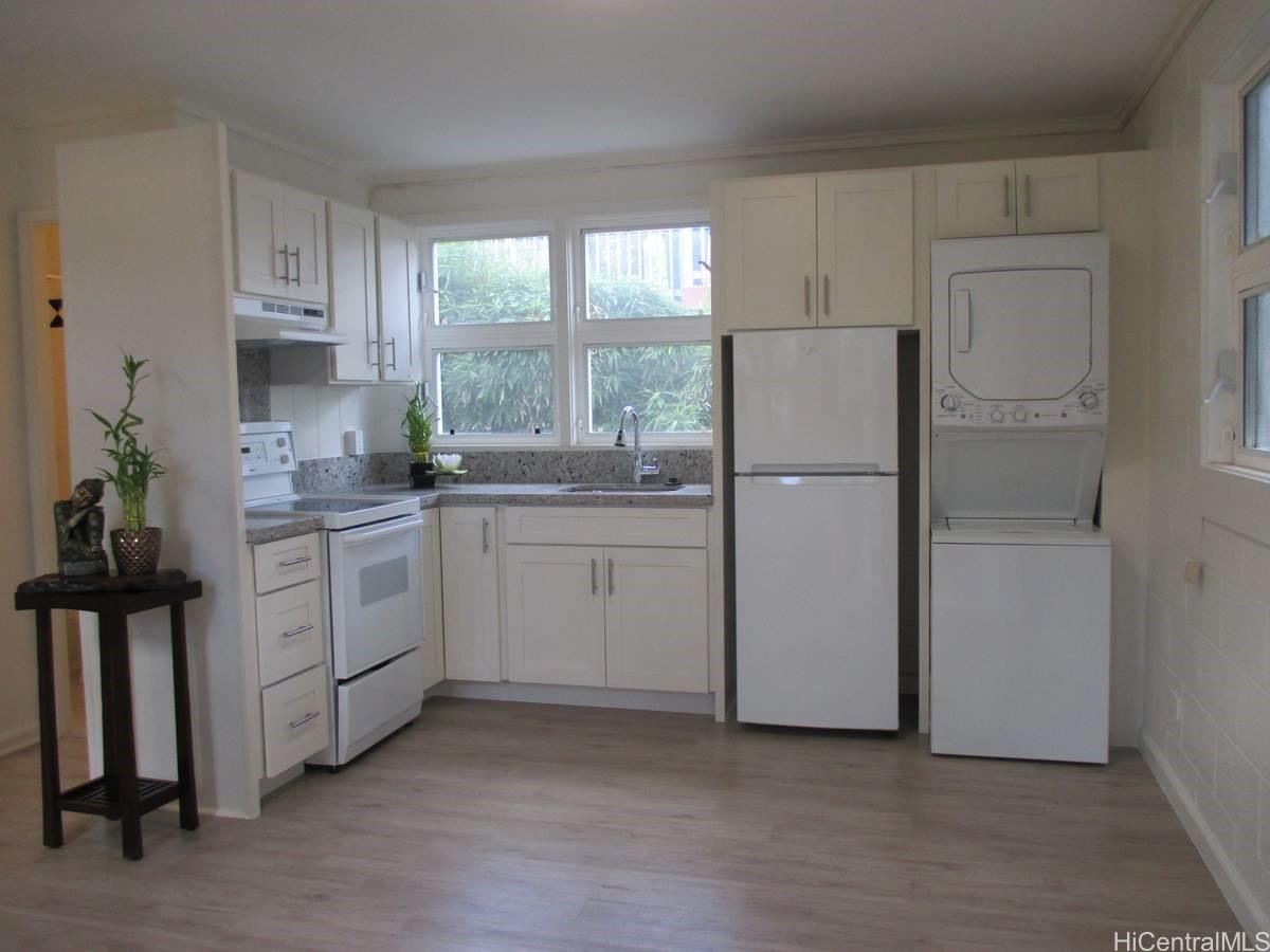 a kitchen with white cabinets and white appliances