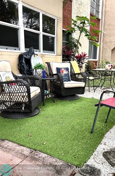 a view of a house with backyard and patio