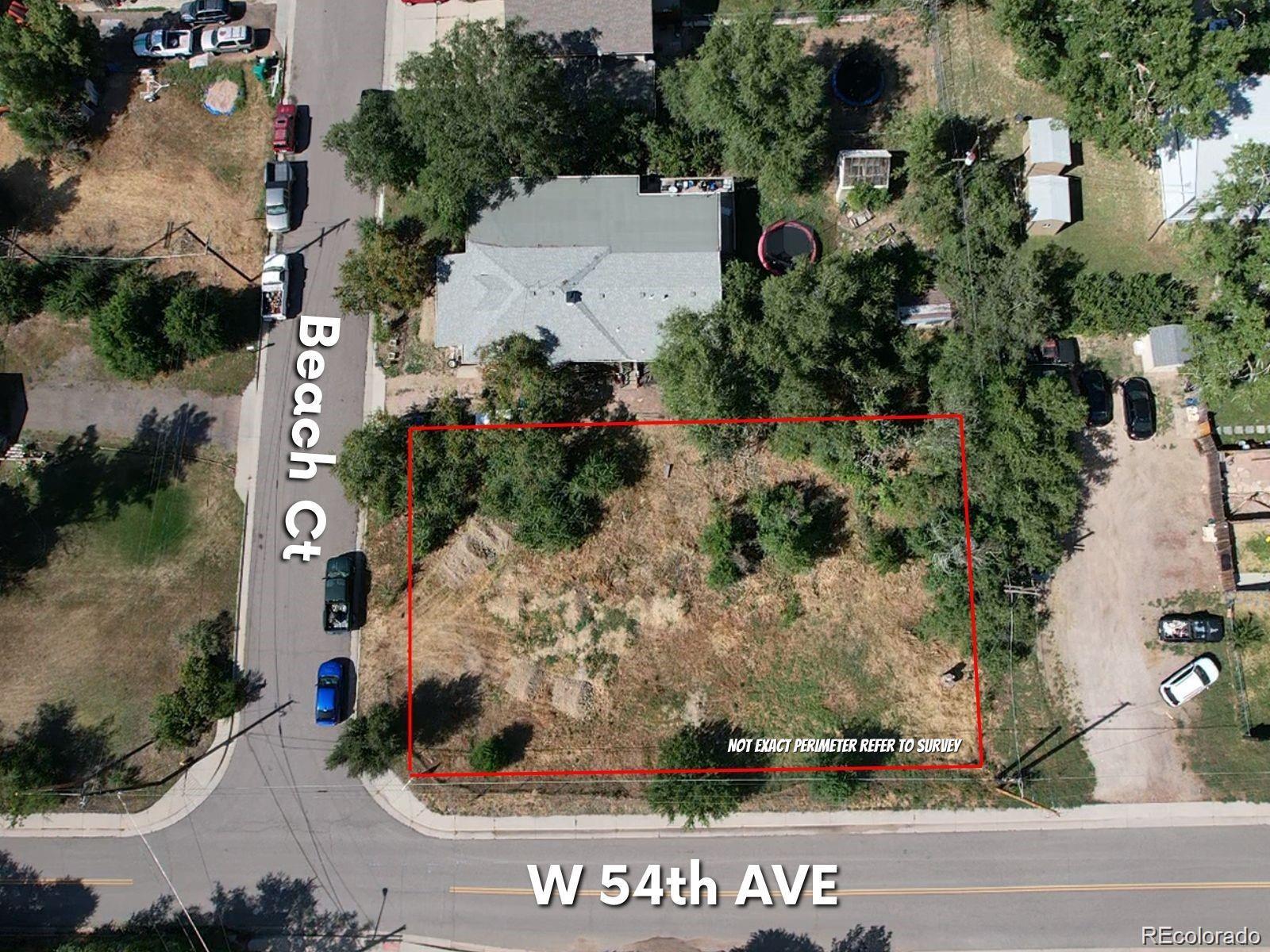 an aerial view of a house with a yard and couple of flower plants