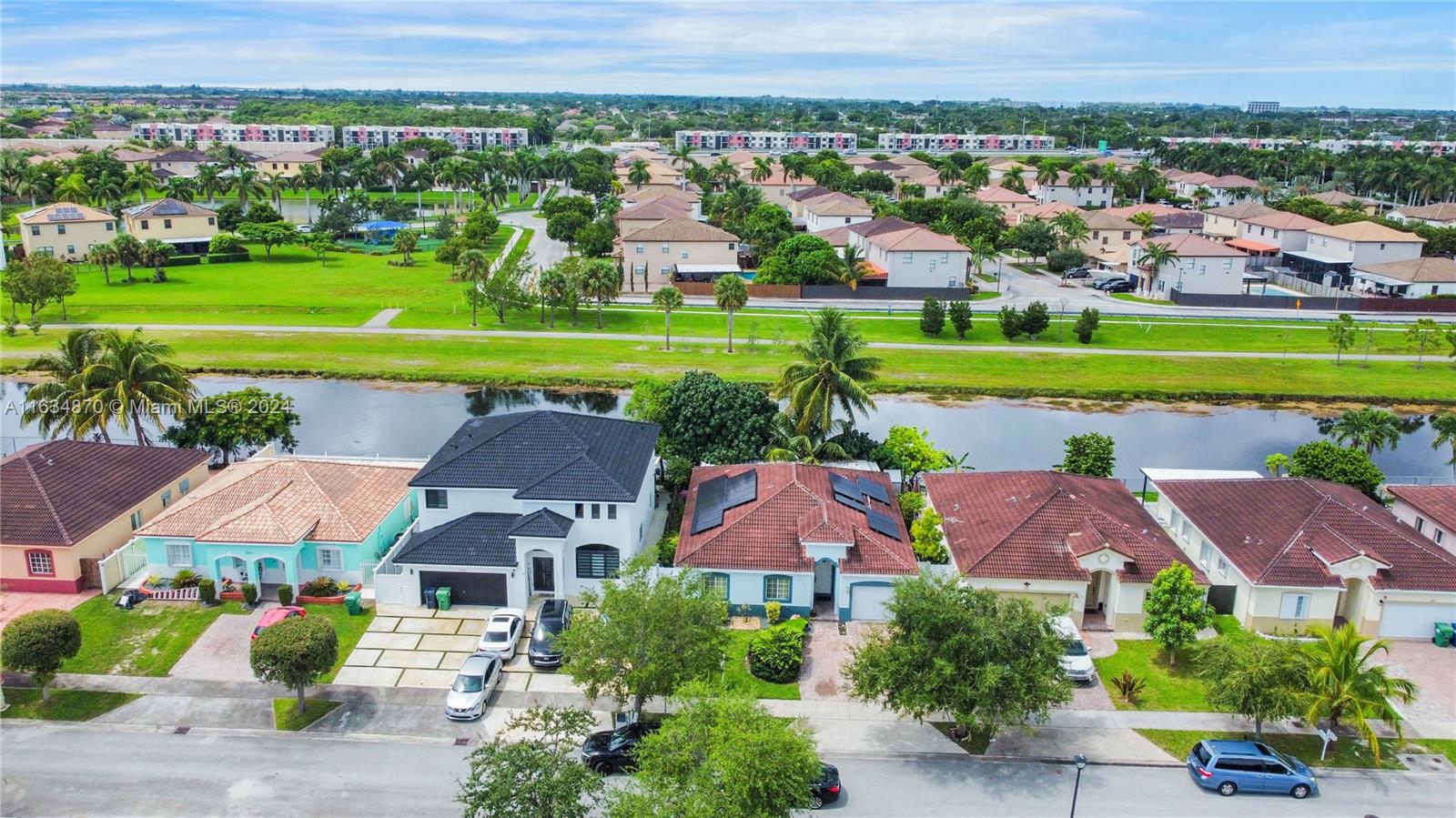 an aerial view of a houses with a garden and trees