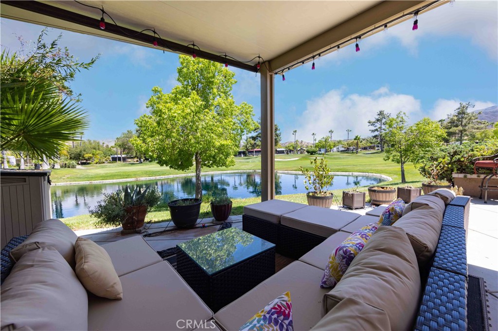 a living room with patio furniture and a garden