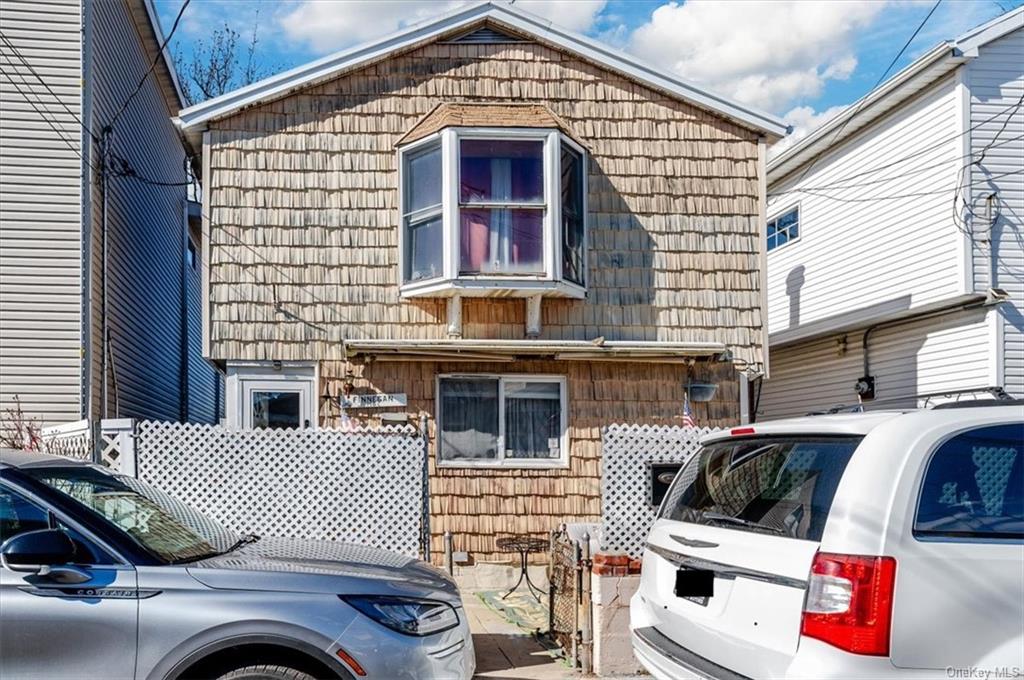 a front view of a house with parking space