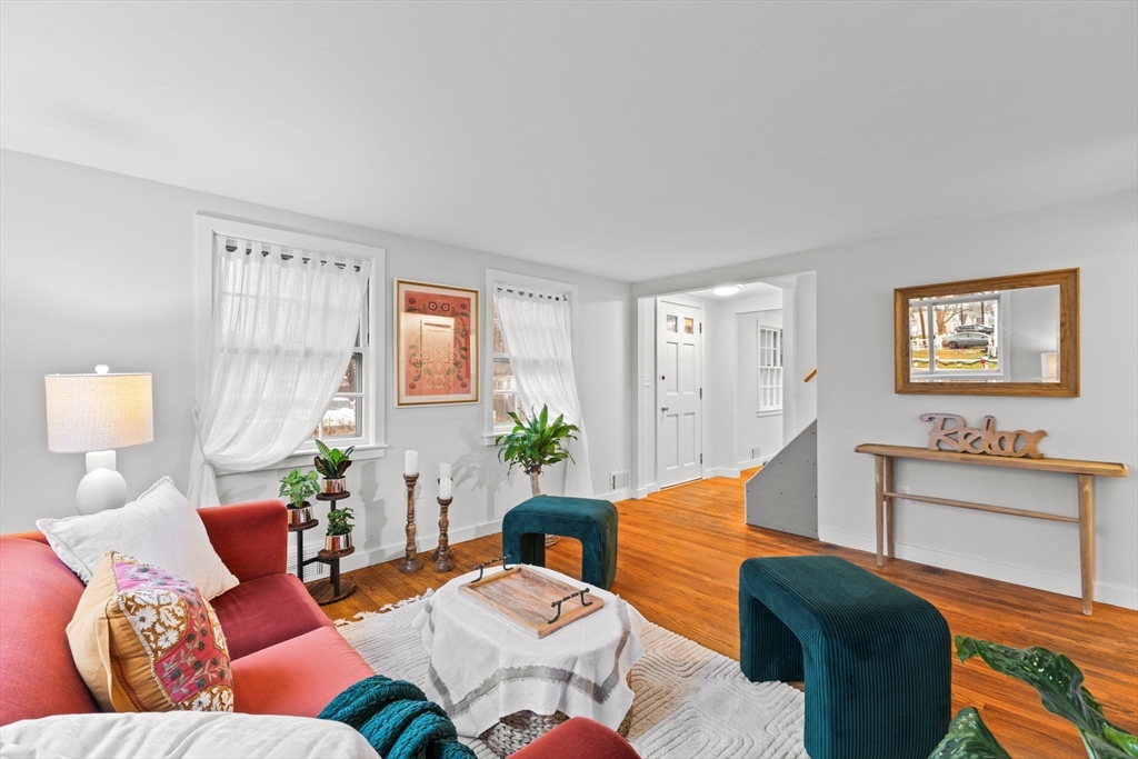 a living room with furniture and wooden floor