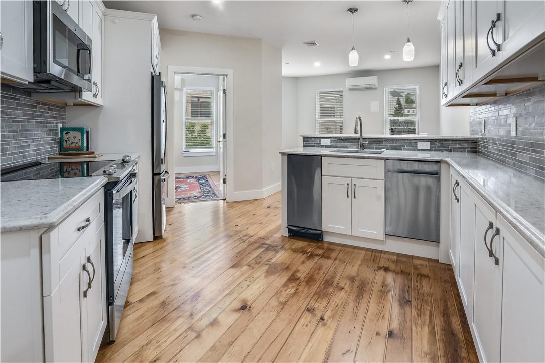 a kitchen with granite countertop a stove top oven and sink