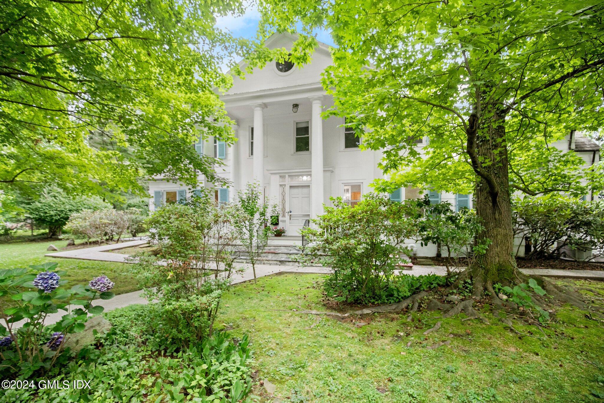 a view of backyard of house with green space