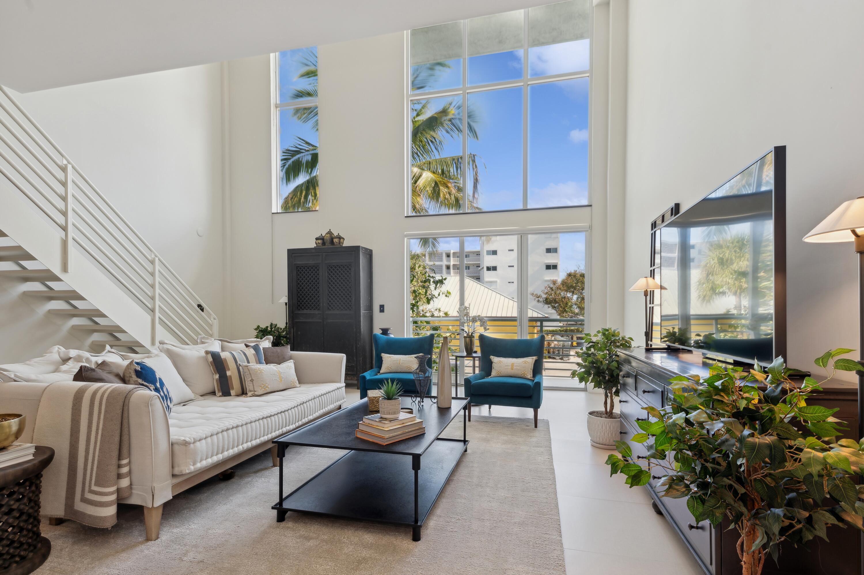 a living room with furniture and a potted plant